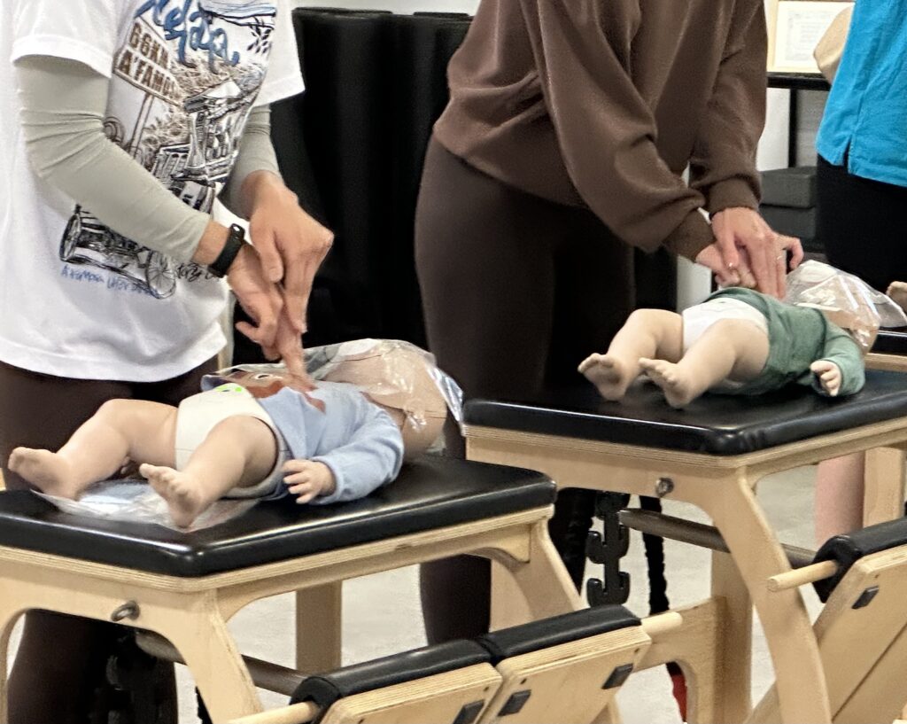 Workplace CPR renewal at child manikins